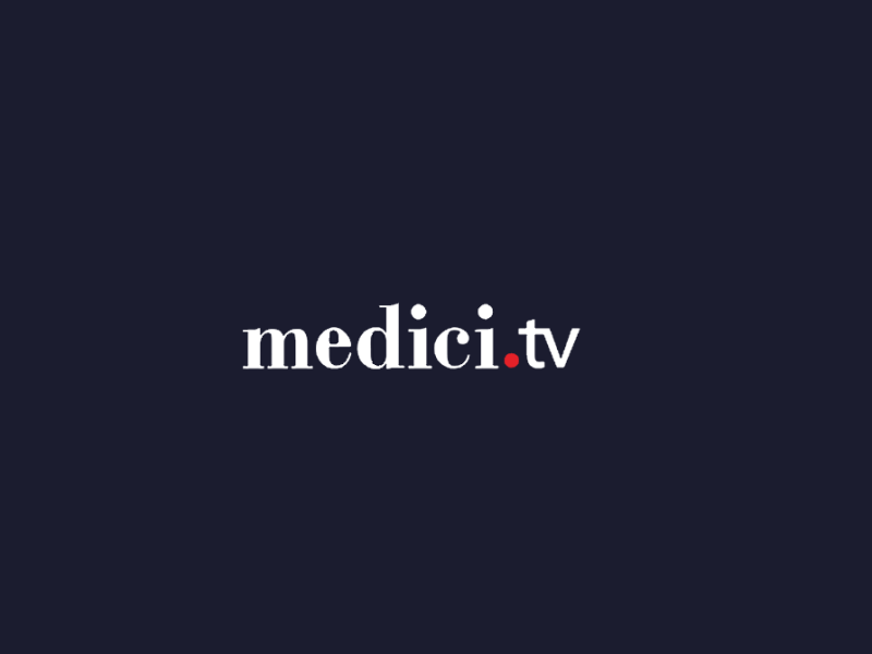 Mørkeblå baggrund med teksten medici og tv i hvid. Punktummet mellem medici og tv er rødt.